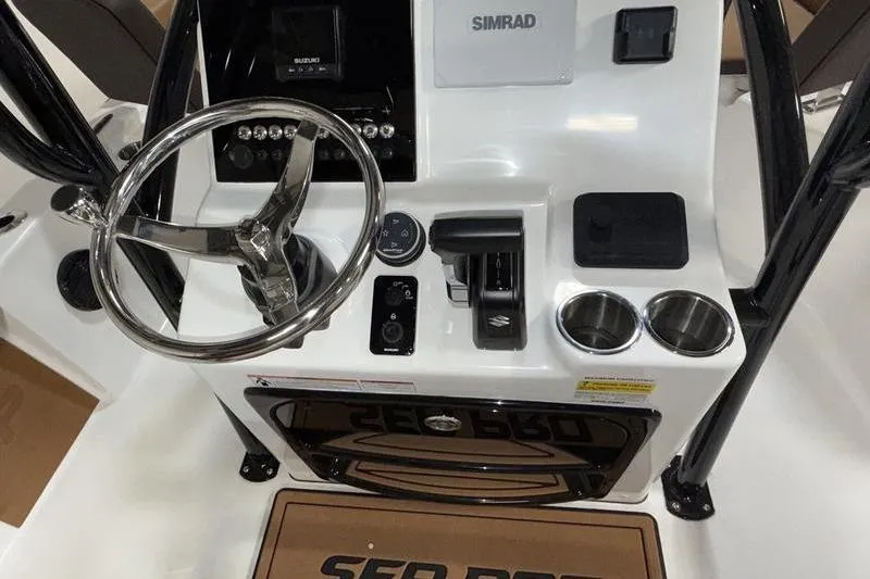 Slide: The Image of 2026 Sea Pro 210 Bay boat console with steering wheel and controls. - 10
