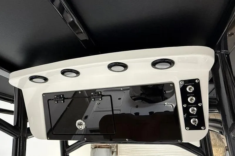Slide: The Image of 2026 Sea Pro 210 Bay boat console with switches and storage compartment. - 11