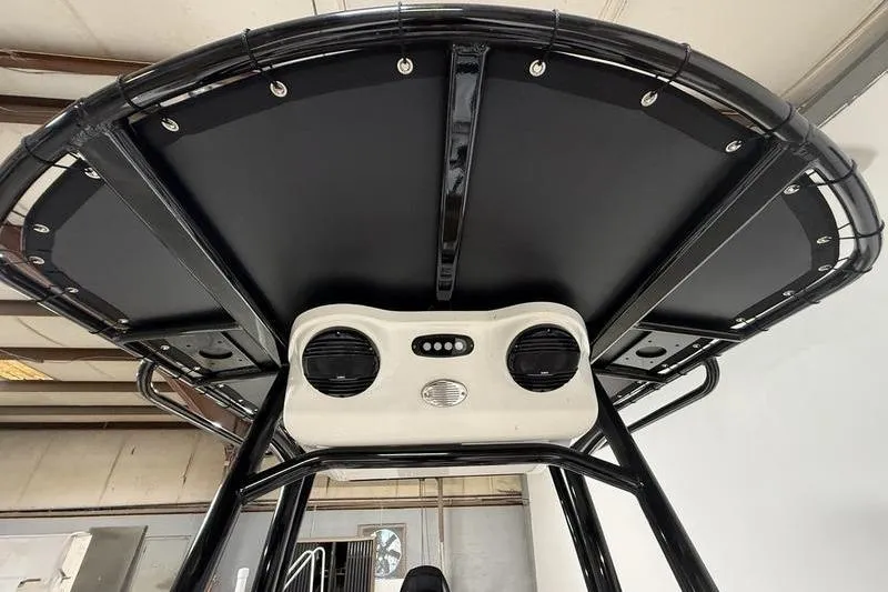 Slide: The Image of T-top view of 2026 Sea Pro 210 Bay boat with speakers and black frame. - 12