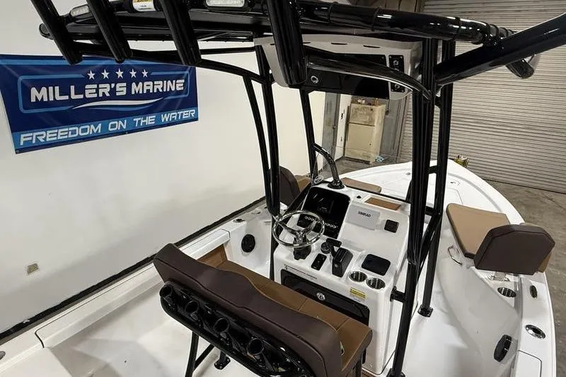 Slide: The Image of 2026 Sea Pro 210 Bay boat interior with steering console at Miller's Marine showroom. - 13