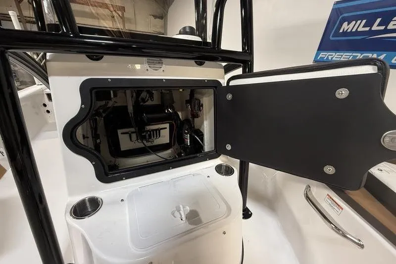 Slide: The Image of 2026 Sea Pro 210 Bay boat console with open storage compartment. - 17