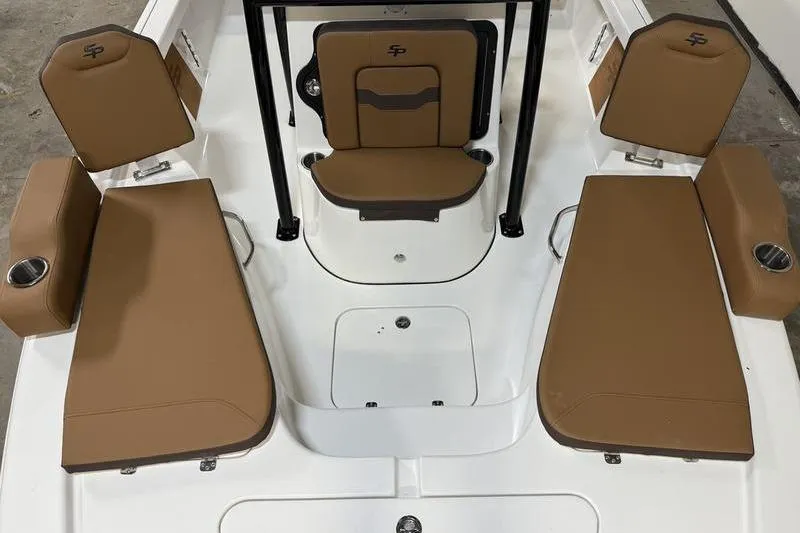 Slide: The Image of 2026 Sea Pro 210 Bay boat interior with tan seating and cup holders. - 19