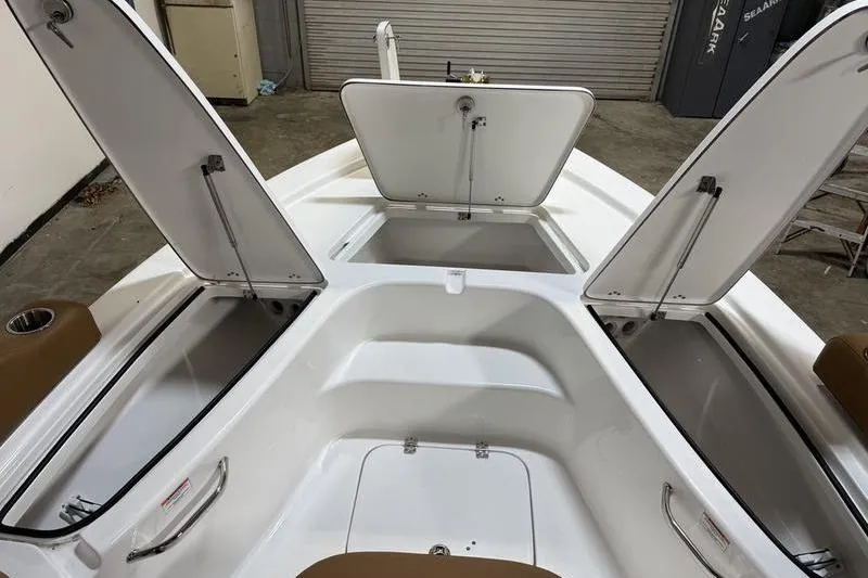 Slide: The Image of 2026 Sea Pro 210 Bay boat interior with open storage compartments. - 21