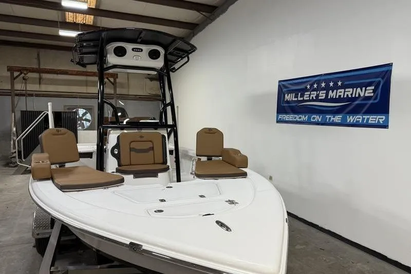 Slide: The Image of 2026 Sea Pro 210 Bay boat displayed indoors at Miller's Marine showroom. - 4