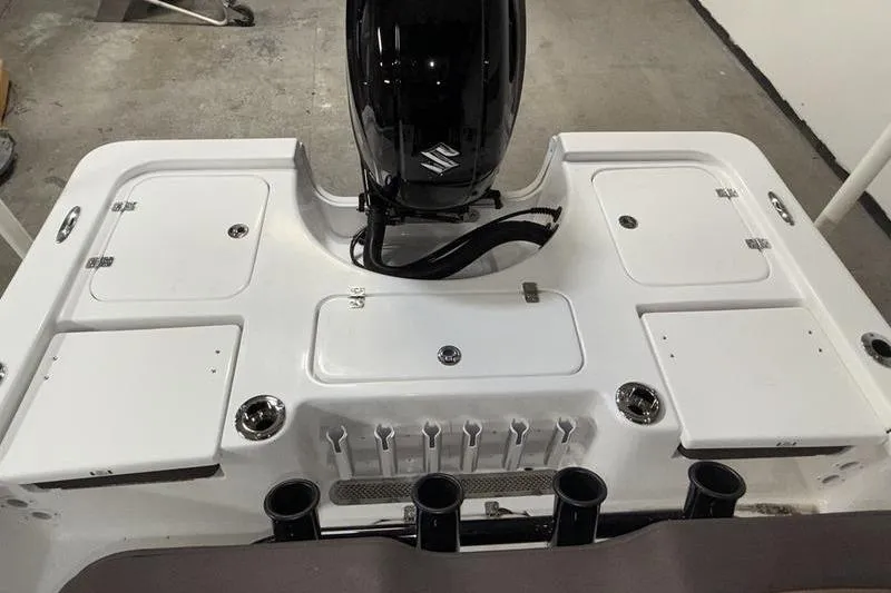 Slide: The Image of 2026 Sea Pro 210 Bay boat's rear deck with motor and storage compartments. - 6