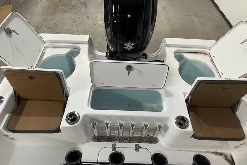 Slide: The Image of 2026 Sea Pro 210 Bay boat interior with storage compartments and motor. - 7