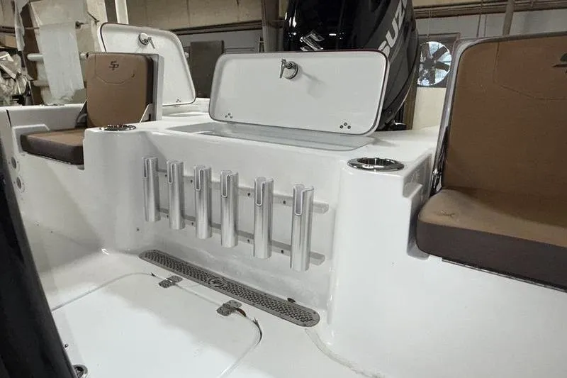 Slide: The Image of 2026 Sea Pro 210 Bay boat interior with rod holders and seating. - 8