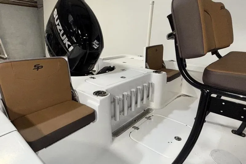 Slide: The Image of 2026 Sea Pro 210 Bay boat interior with Suzuki engine and seating. - 9