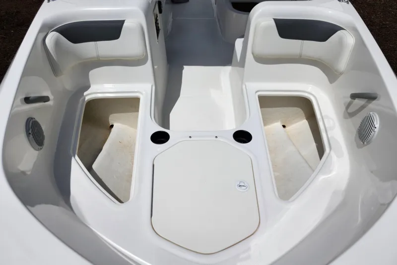 Slide: The Image of 2021 Bayliner Element E18 boat interior with seating and storage compartments. - 11