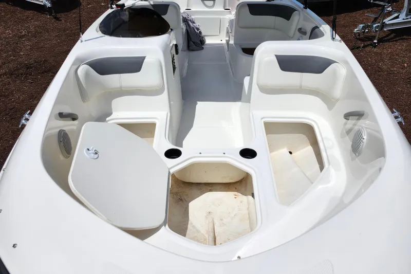 Slide: The Image of 2021 Bayliner Element E18 boat interior with seating and storage compartments. - 12