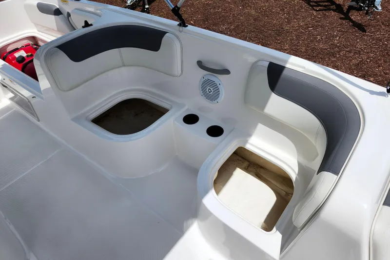 Slide: The Image of 2021 Bayliner Element E18 boat interior with seating and storage compartments. - 15
