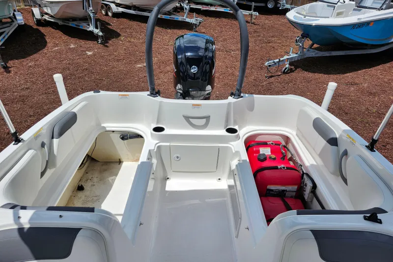Slide: The Image of 2021 Bayliner Element E18 boat interior with seating and storage compartments. - 17
