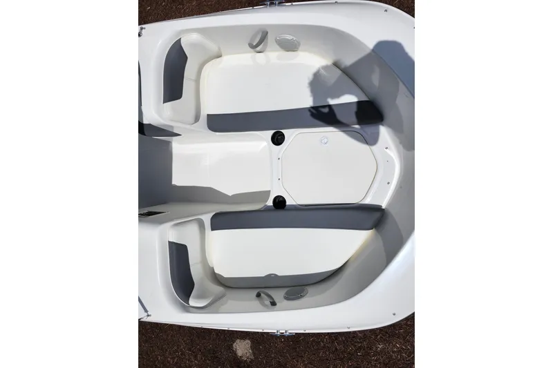 Slide: The Image of 2021 Bayliner Element E18 boat interior with white and gray seating arrangement. - 19