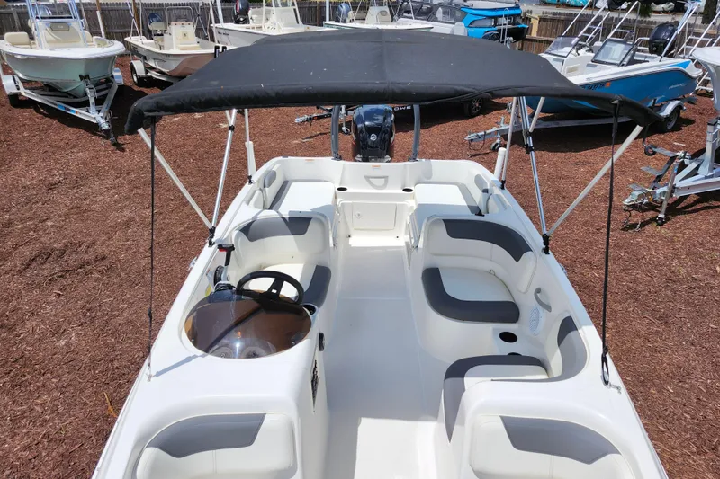 Slide: The Image of 2021 Bayliner Element E18 boat with canopy, spacious seating, and modern design. - 20