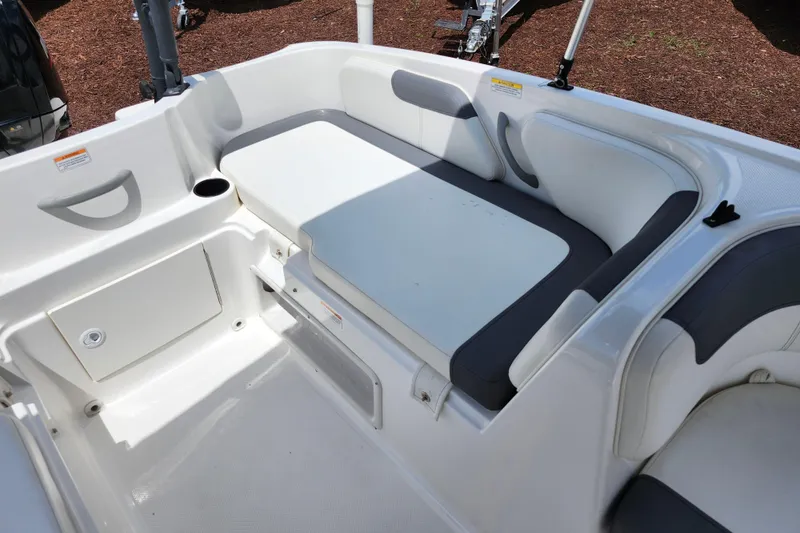 Slide: The Image of 2021 Bayliner Element E18 boat interior with white and gray seating. - 26