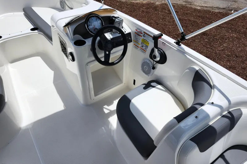 Slide: The Image of 2021 Bayliner Element E18 boat interior with steering wheel and seating area. - 29