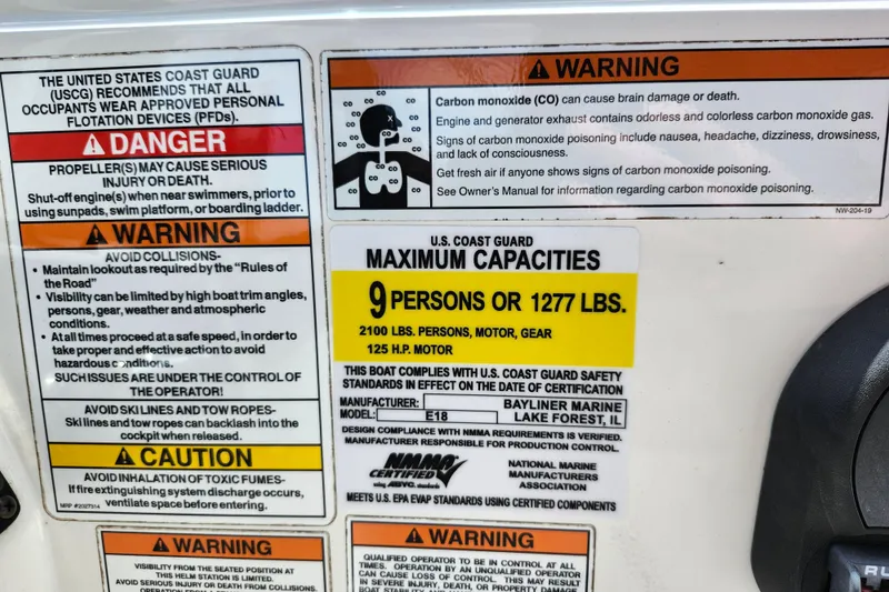 Slide: The Image of Safety warnings and capacity limits on a 2021 Bayliner Element E18 boat. - 30