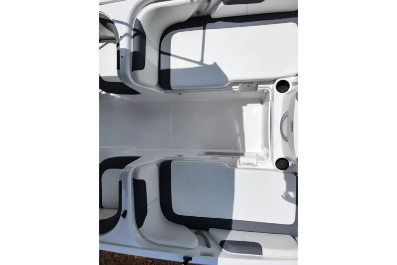 Slide: The Image of 2021 Bayliner Element E18 boat interior with white seating and storage compartments. - 36
