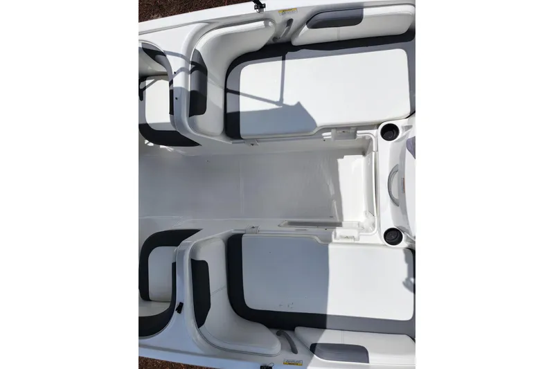Slide: The Image of 2021 Bayliner Element E18 boat interior with white seating and storage compartments. - 37