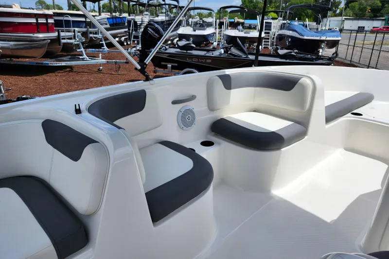 Slide: The Image of 2021 Bayliner Element E18 boat interior with gray and white seating, docked at marina. - 38
