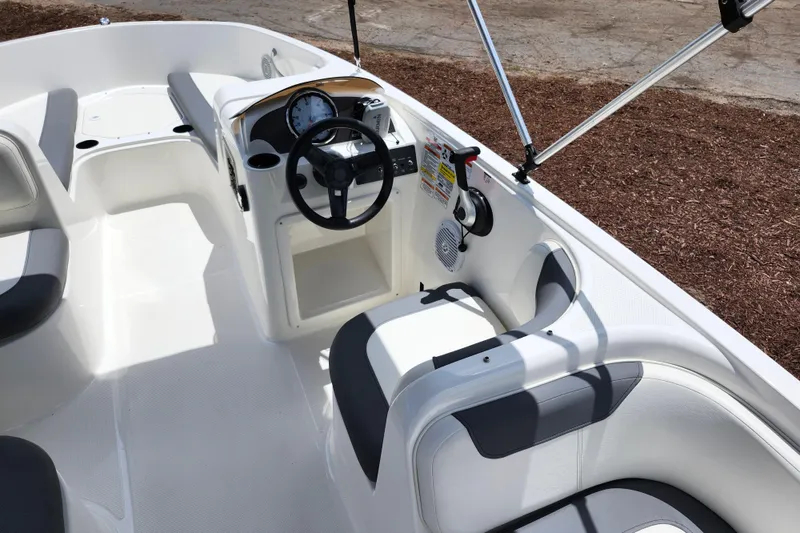 Slide: The Image of 2021 Bayliner Element E18 boat interior with steering wheel and seating. - 40