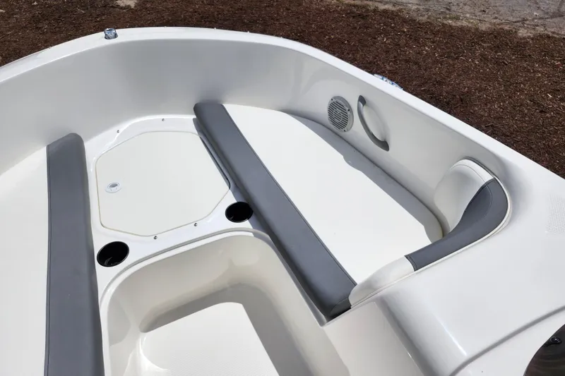 Slide: The Image of 2021 Bayliner Element E18 boat interior with gray seating and cup holders. - 42