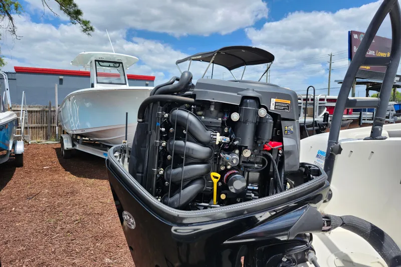 Slide: The Image of 2021 Bayliner Element E18 boat with exposed engine, parked outdoors. - 45