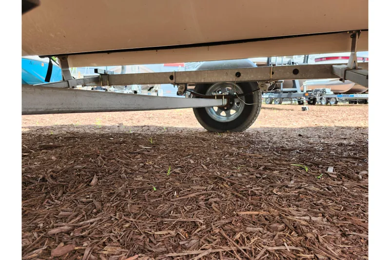 Slide: The Image of 2021 Bayliner Element E18 trailer wheel on mulch ground. - 46