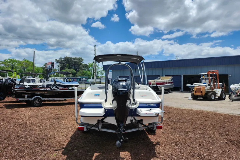 Slide: The Image of 2021 Bayliner Element E18 boat displayed outdoors under a partly cloudy sky. - 6