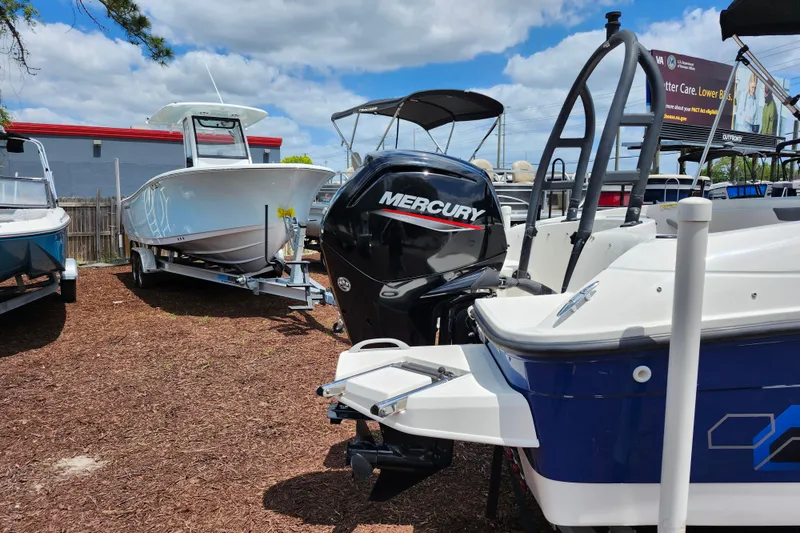 Slide: The Image of 2021 Bayliner Element E18 with Mercury outboard motor in a boatyard. - 9