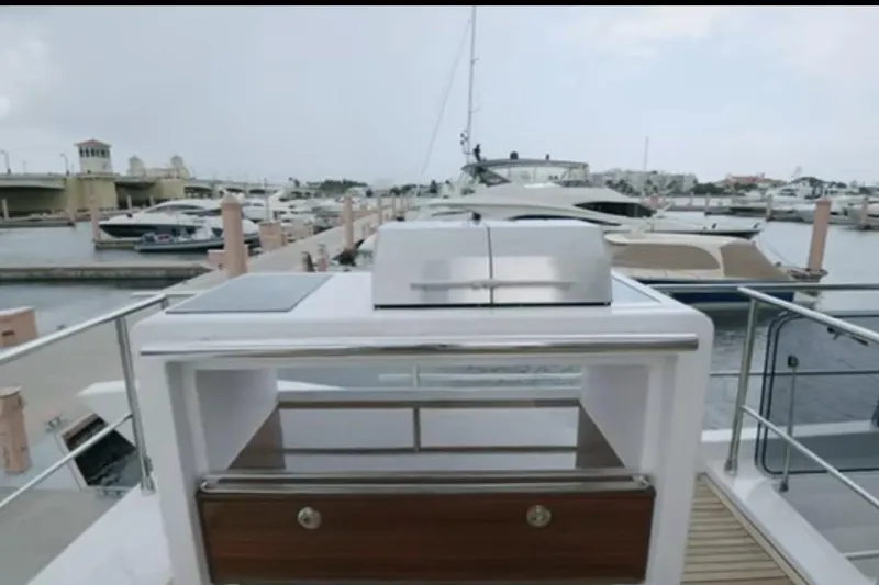 Slide: The Image of Luxury Azimut 66 yacht docked at marina, showcasing sleek design and modern amenities. - 30