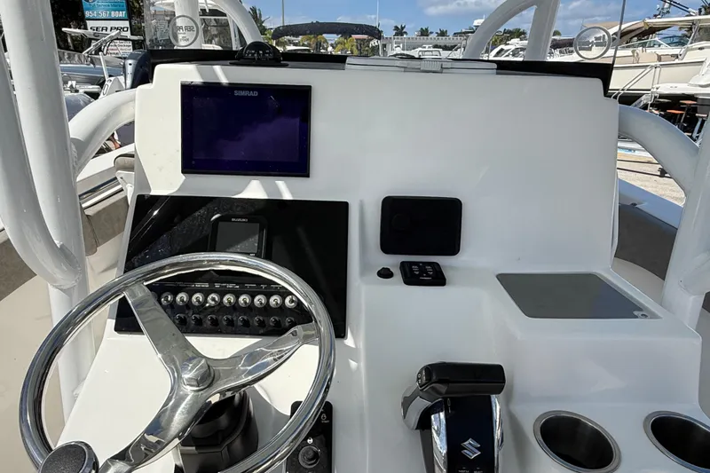 Slide: The Image of 2023 Sea Pro 219 Center Console dashboard with steering wheel and navigation equipment. - 12