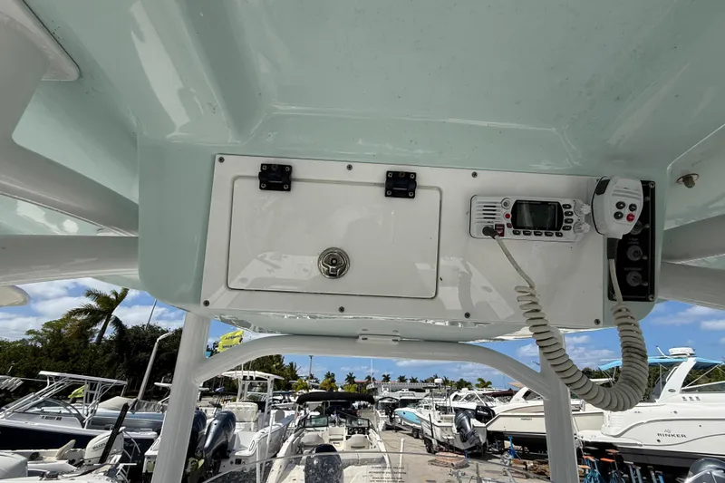 Slide: The Image of 2023 Sea Pro 219 Center Console boat dashboard with radio and storage compartment. - 13