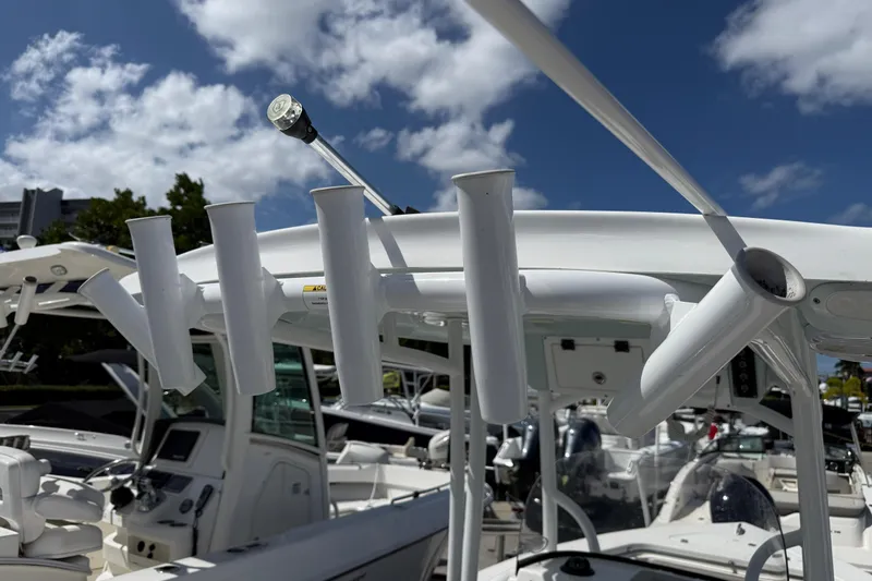 Slide: The Image of 2023 Sea Pro 219 Center Console boat with rod holders under a clear blue sky. - 15