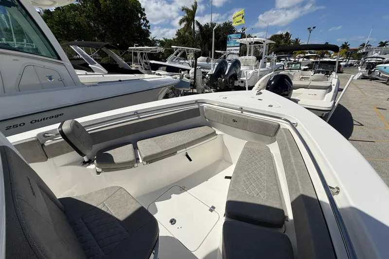 Slide: The Image of 2023 Sea Pro 219 Center Console boat with spacious seating, docked among other boats. - 18