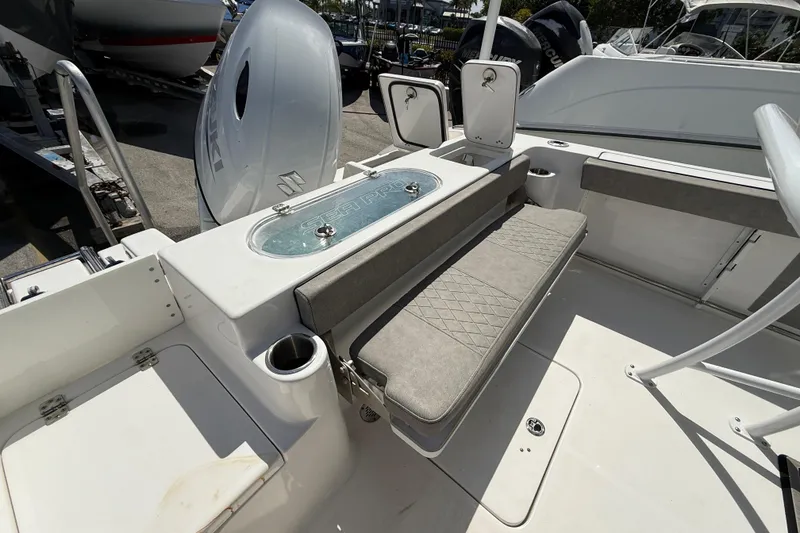 Slide: The Image of 2023 Sea Pro 219 Center Console boat interior with seating and storage compartments. - 4
