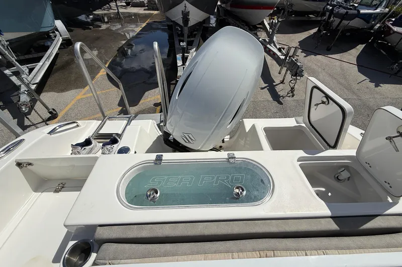Slide: The Image of 2023 Sea Pro 219 Center Console boat with engine and storage compartments. - 5