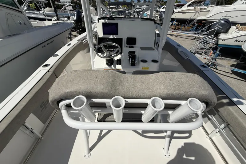 Slide: The Image of 2023 Sea Pro 219 Center Console boat interior with rod holders and steering console. - 6