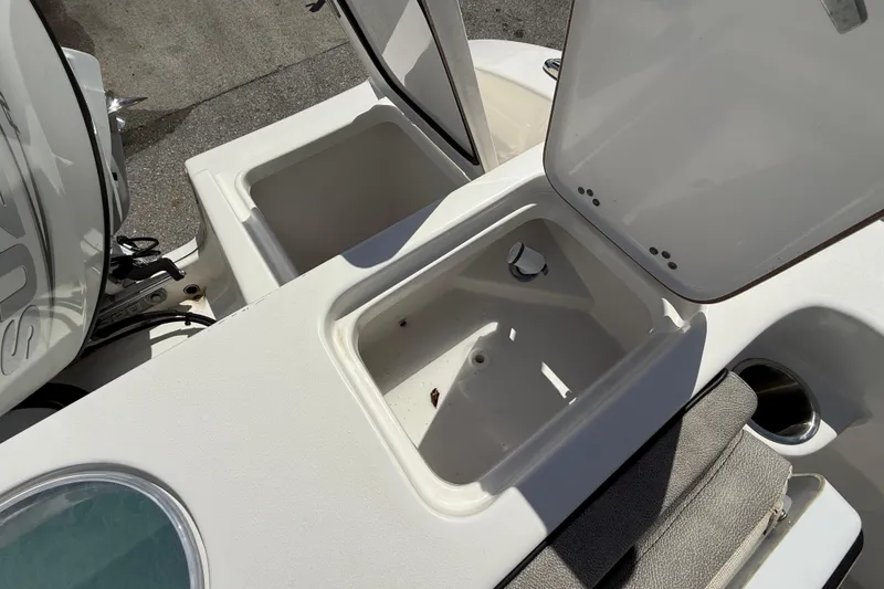 Slide: The Image of 2023 Sea Pro 219 Center Console boat storage compartments and engine detail. - 7