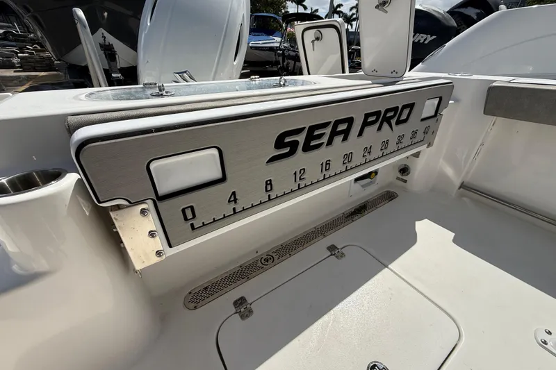 Slide: The Image of 2023 Sea Pro 219 Center Console boat interior with measurement scale and storage compartments. - 8