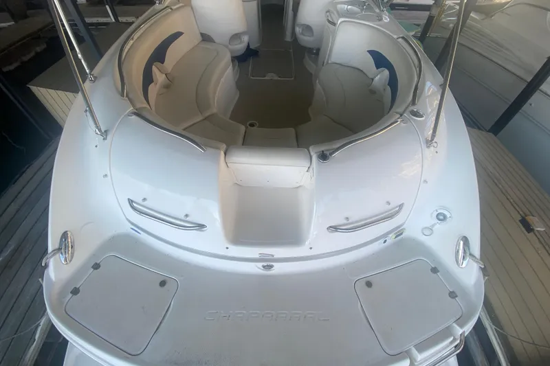 Slide: The Image of 2003 Chaparral Sunesta 263 boat interior with white seating and sleek design. - 11