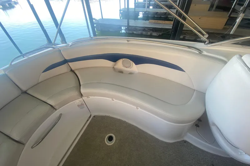 Slide: The Image of 2003 Chaparral Sunesta 263 boat interior with curved seating and blue accents. - 15