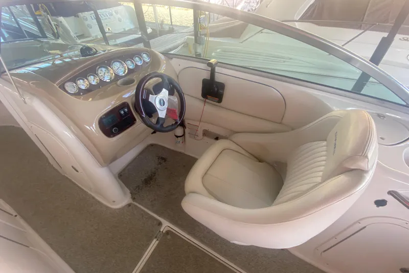 Slide: The Image of 2003 Chaparral Sunesta 263 boat interior with steering wheel and dashboard controls. - 24