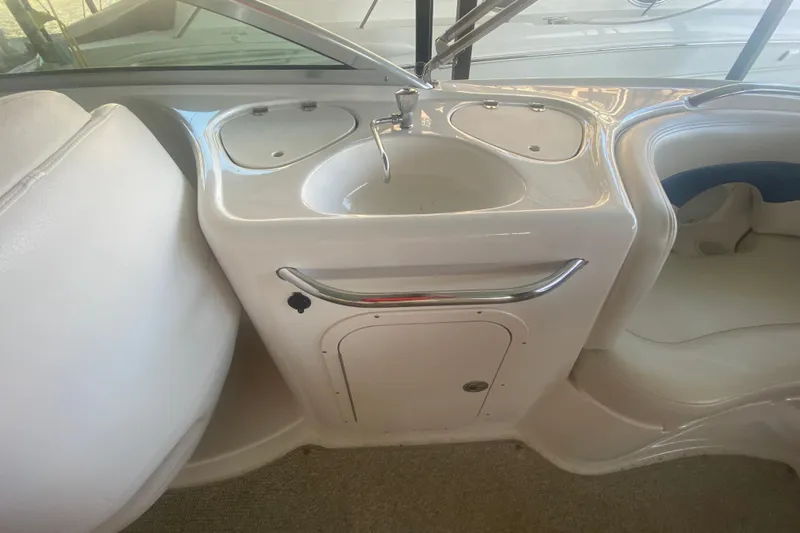 Slide: The Image of 2003 Chaparral Sunesta 263 boat interior with sink and seating area. - 25