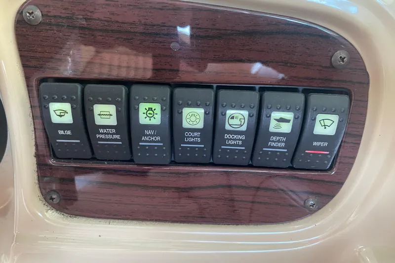 Slide: The Image of Control panel of a 2003 Chaparral Sunesta 263 boat with labeled switches. - 29