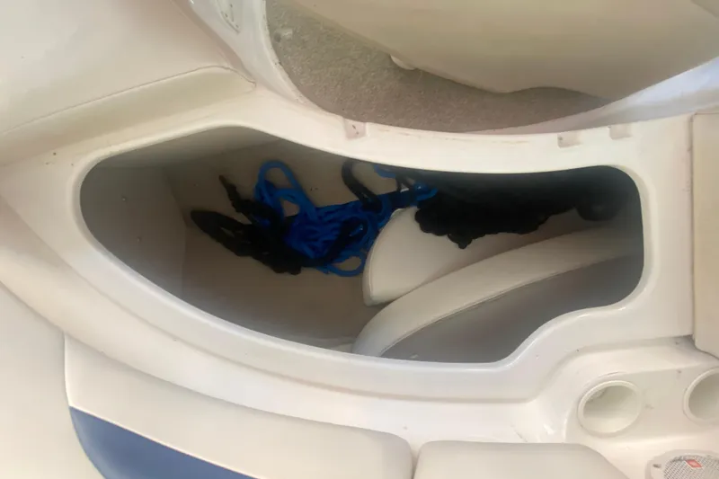 Slide: The Image of Storage compartment in a 2003 Chaparral Sunesta 263 boat with blue and black ropes. - 31