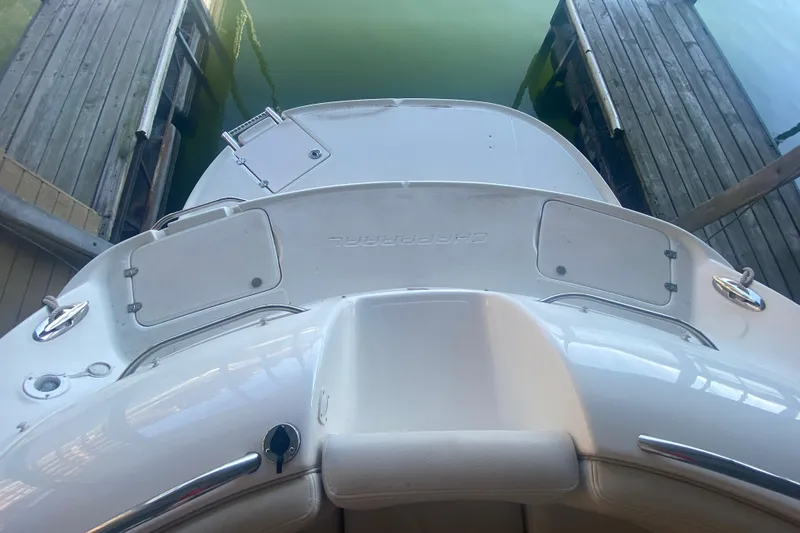 Slide: The Image of 2003 Chaparral Sunesta 263 boat docked, viewed from above, showcasing rear deck and swim platform. - 34