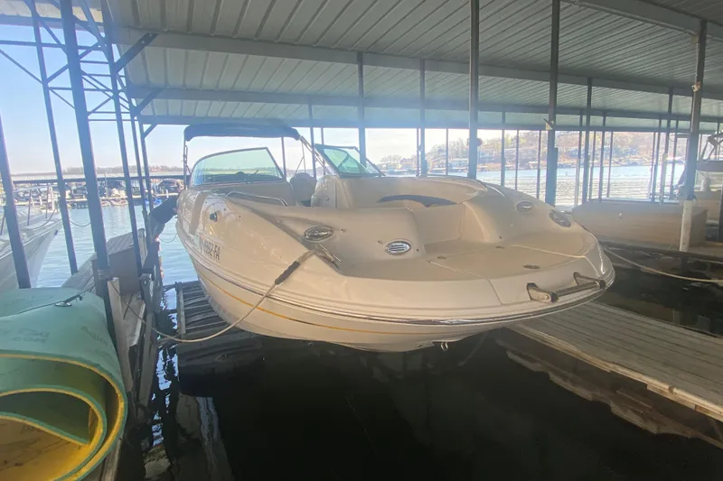 Slide: The Image of 2003 Chaparral Sunesta 263 boat docked in a covered marina. - 6