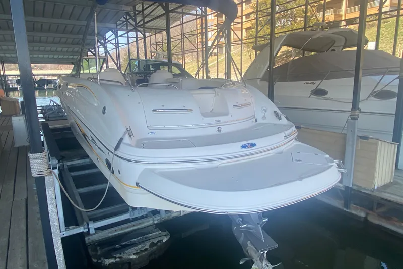 Slide: The Image of 2003 Chaparral Sunesta 263 boat docked in a covered marina. - 9