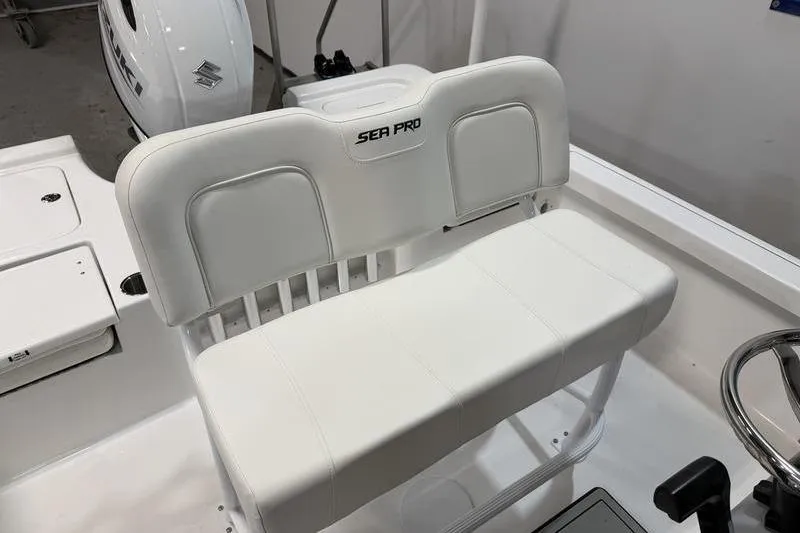 Slide: The Image of 2026 Sea Pro 210 Bay boat interior with white seating and steering wheel. - 10